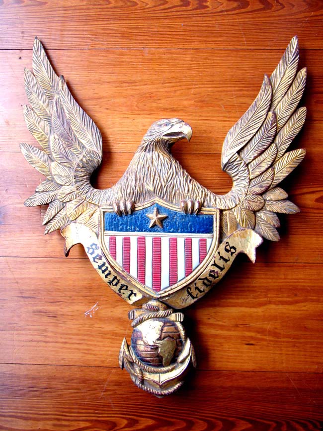 A wonderful early 20th century carved eagle plaque  with the U.S. Marine Corp emblem anf their motto "Semper fideles."
